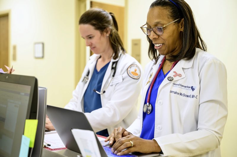 Two clinicians at a computer at Good Samaritan Health Centers of Gwinnett