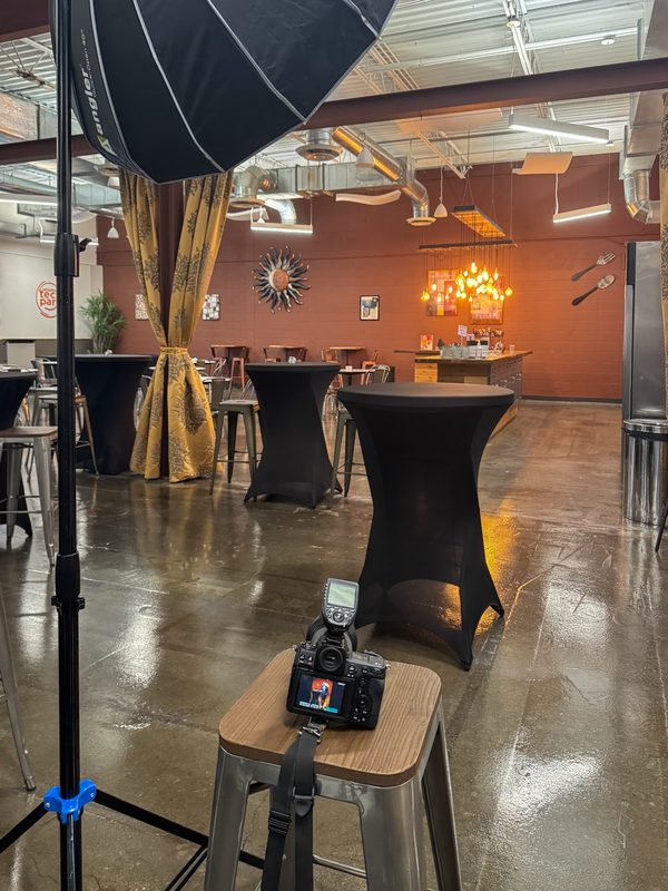 Softbox, light stand and camera set up for on-location headshots in a restaurant venue