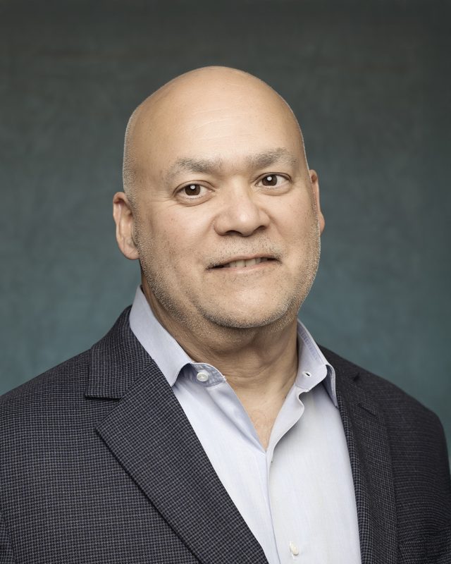 Trademark Property Management executive headshot on a teal backdrop