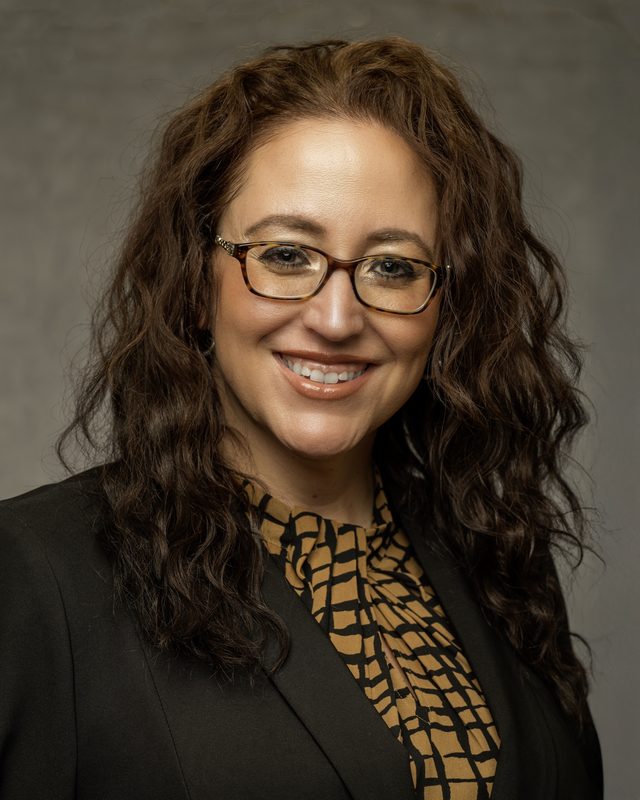 Trademark Property Management headshot of a smiling woman in glasses