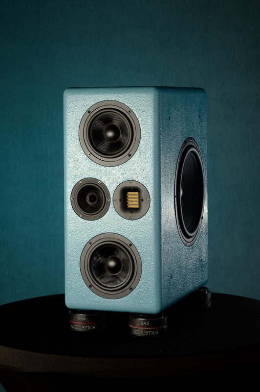 Teal SAS Acoustics studio monitor on a teal backdrop